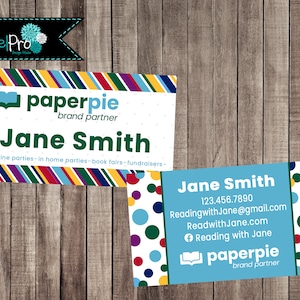 May include: Two business cards with a wooden background. One card features the name "Jane Smith" and "paperpie brand partner" with a colorful striped border. The second card has contact information and a polka dot design.