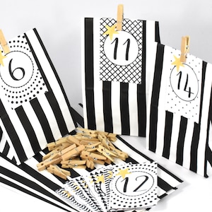 Advent calendar DIY with block bag, numbers and wooden clips with spiritual motifs