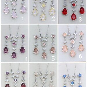 Puede incluir: Nueve juegos de joyas de novia plateadas con colgantes de cristal en forma de l&aacute;grima y detalles florales. Los juegos est&aacute;n dispuestos en una cuadr&iacute;cula con cada juego numerado del 1 al 9.