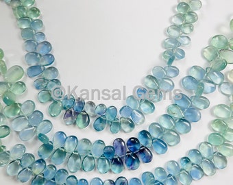May include: A strand of blue and green gemstone beads, with a tassel at the end. The beads are oval shaped and have a smooth, polished finish.