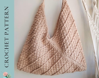 May include: A crocheted tote bag in a light beige color with a v-shaped opening. The bag has a textured, diagonal stitch pattern.