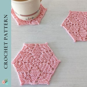 May include: Three pink crocheted coasters with a delicate, lacy pattern. The coasters are hexagonal in shape and have a delicate, openwork design.
