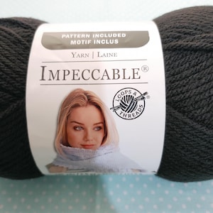 May include: A ball of black yarn, branded as "Impeccable" with the Loops & Threads logo. The label also states "Pattern Included". The yarn is a deep, solid colour, ideal for various knitting and crochet projects.
