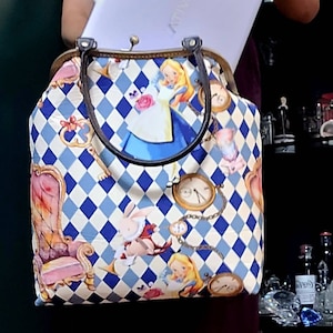 Alice in Wonderland mega size shoulder bag or handbag or school bag or lab top bag.  Kiss lock metal frame.