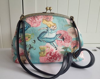 Alice in Wonderland Drink Me print velour shoulder bag or crossbody with metal kiss lock frame and adjustable strap