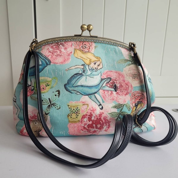 Alice in Wonderland Drink Me print velour shoulder bag or crossbody with metal kiss lock frame and adjustable strap