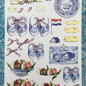 Immagini olandesi per la lavorazione della carta, tra cui tulipani, scarpe di legno e ceramica blu di Delft