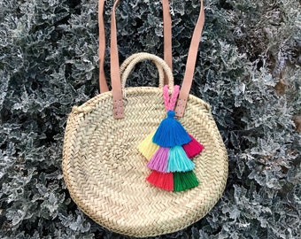 round straw basket with pom-poms