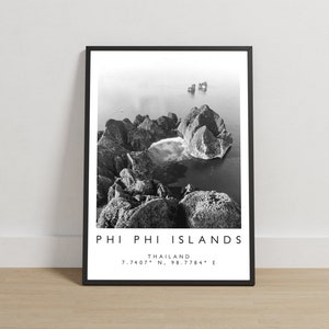 May include: Monochrome framed print featuring the Phi Phi Islands in Thailand. The image shows an aerial view of the islands and sea. The print includes the text "PHI PHI ISLANDS THAILAND 7.7407° N, 98.7784° E".