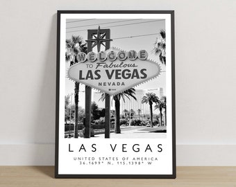 May include: A black and white framed wall art print featuring the iconic Welcome to Fabulous Las Vegas sign with palm trees in the background. The text LAS VEGAS UNITED STATES OF AMERICA 36.1699 N, 115.1398 W is printed at the bottom.