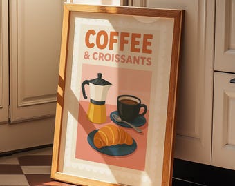 Könnte beinhalten: Ein gerahmter Druck mit rosa Hintergrund und einer Vintage-Illustration einer Kaffeekanne, einer Tasse Kaffee und einem Croissant. Der Text auf dem Druck lautet "Coffee & Croissants".