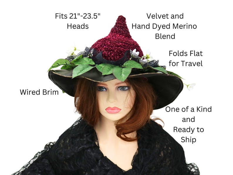 A crochet burgundy and black witch hat with a wired brim. The hat is decorated with green leaves, white flowers, and black lace. The hat is made of velvet and hand-dyed merino blend. The hat is one of a kind and ready to ship. Fits 21 to 23.5 inch heads. Folds flat for travel.