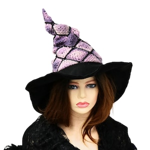 May include: A purple and black witch hat with a pointed crown and a wide brim. The hat is made of crocheted fabric and has a geometric pattern.