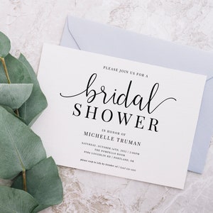 May include: A white bridal shower invitation with black text. The invitation reads "Please join us for a bridal shower in honor of Michelle Truman. Saturday, October 14th, 2022 | 2:00PM The Pompello Room 9384 Loughlin Rd | Portland, OR Please RSVP by October 1st | (555) 555-5555"