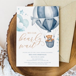 May include: A baby shower invitation with a watercolor illustration of a blue and white hot air balloon with a teddy bear in the basket. The text reads "We can barely wait" in a cursive font. The invitation is for Melanie Robinson and is scheduled for May 6th at 2:00 PM at The Greenhouse.