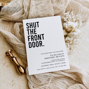 May include: A white card with black text that reads "SHUT THE FRONT DOOR." The card is an invitation to a housewarming party at 374 Willow St, Andover, MA 01810 on Saturday, April 15th at 7:00PM. RSVP to Joshua by April 10th at 123.456.7890.