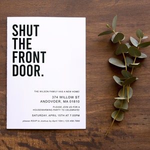May include: A white card with black text that reads "SHUT THE FRONT DOOR." The card is a housewarming party invitation for the Wilson family at 374 Willow St, Andover, MA 01810. The party is on Saturday, April 15th at 7:00 PM. RSVP to Joshua by April 10th at 123.456.7890.