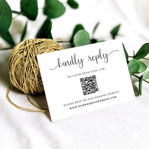 May include: White card with black text that reads "kindly reply" in cursive. Below the text is a black and white QR code with the text "NO LATER THAN JUNE 13TH". Below the QR code is the text "PLEASE RSVP ON OUR WEDDING WEBSITE: www.OURWEDDINGWEBSITE.COM"