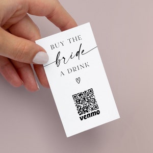 May include: White card with black text that reads "BUY THE bride A DRINK" with a heart symbol. A black and white QR code is below the text with the word "venmo" underneath.