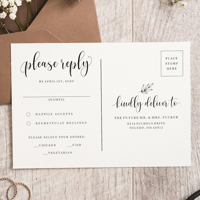 May include: A white RSVP card with black text. The card has a section for the guest's name, a choice of "Happily Accepts" or "Regretfully Declines", and a choice of entree: "Chicken", "Fish", or "Vegetarian". The card also includes a space for a stamp and the address to send the card to: "The Future Mr. & Mrs. Tucker, 8214 Nichols Drive, Toledo, OH 43612".