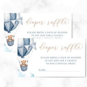 May include: Two white cards with blue and white hot air balloon illustrations and the text "diaper raffle" in brown cursive. The text on the cards reads "Please bring a pack of diapers in any size for a chance to win a special prize!"
