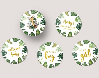 May include: Five round stickers with a tropical leaf design. The stickers feature gold text that says "welcome baby", "it's a boy", "it's a girl", "Avery's Baby Shower 09.06.XX", and a design with animals.