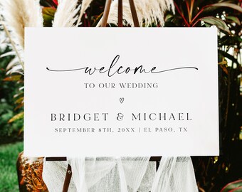 May include: White wedding welcome sign with black calligraphy text that reads "welcome to our wedding" with a heart symbol and the names "Bridget & Michael" and the date "September 8th, 20XX" and location "El Paso, TX".