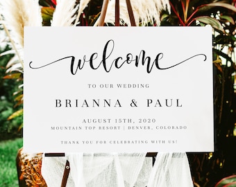 May include: White welcome sign with black calligraphy text. The sign reads "welcome to our wedding Brianna & Paul August 15th, 2020 Mountain Top Resort Denver, Colorado Thank you for celebrating with us!"