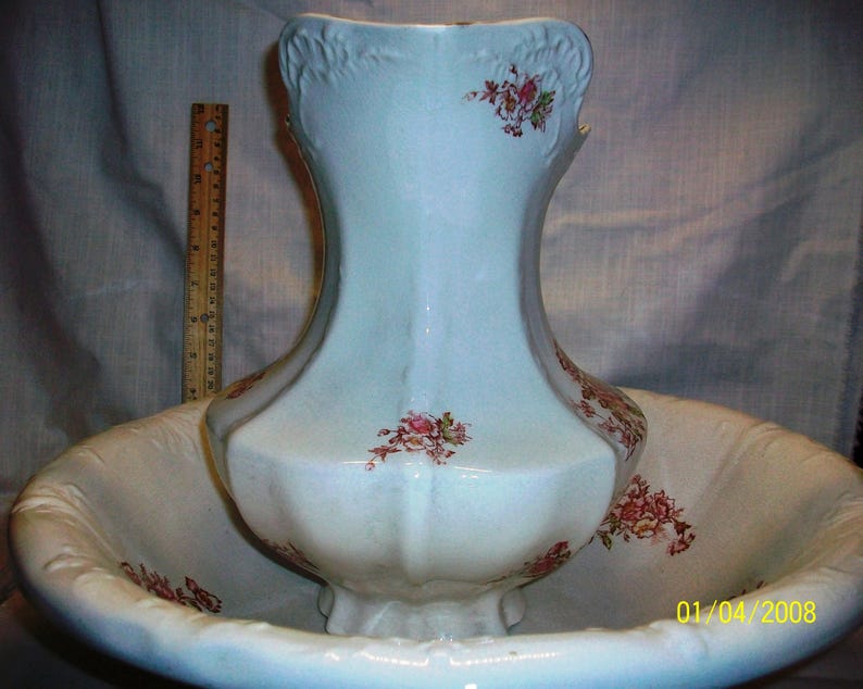 Listing 233 is the Revere Pottery White Floral Pitcher And Basin