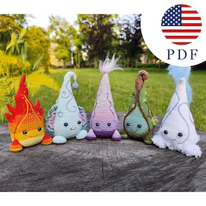 May include: Five crocheted plush figures in cone shapes, each with a unique color scheme: red and yellow, light blue, purple and pink, green and brown, and white with blue accents. Each figure features black eyes and a small stitched smile.
