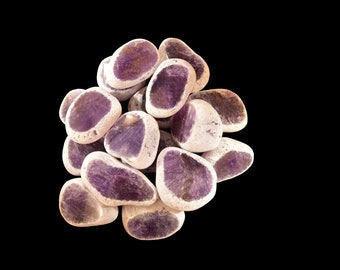 May include: A cluster of smooth, polished amethyst stones with a purple and white colour pattern. The stones are arranged in a cluster, with some overlapping.