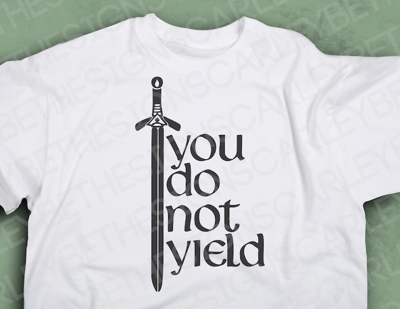 May include: White t-shirt with a black graphic of a sword and the words "you do not yield". The design is centered on the front of the shirt. The shirt is made of a soft material.