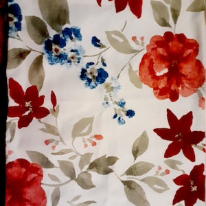 May include: White fabric with a floral pattern featuring red, pink, and blue flowers. The flowers are painted in a watercolor style and have a soft, romantic feel.