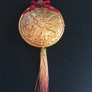 Vintage Coppertone Large Round Scrolled Metal Ornament, with Red Bow Trim and Gold/Red Tassell.