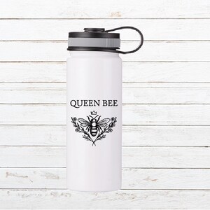 May include: White stainless steel water bottle with a black lid and a black carrying handle. The bottle has a black and white graphic of a bee with a crown on its head and the text "QUEEN BEE".