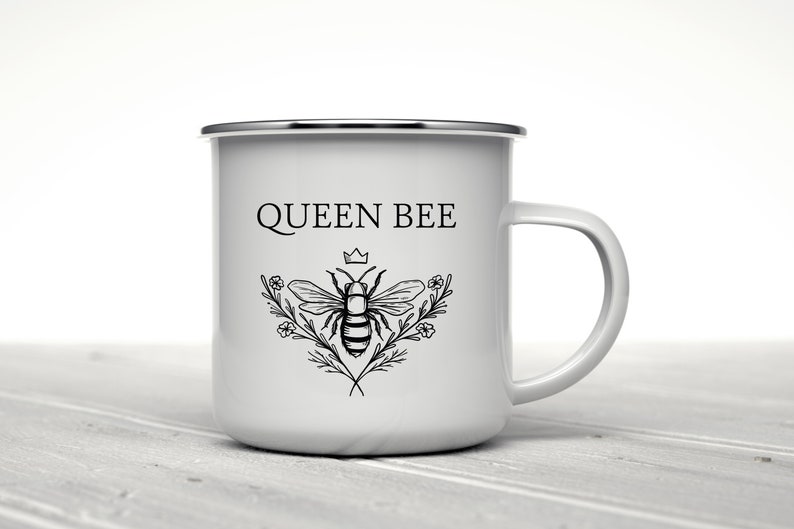 May include: White enamel mug with a black and white illustration of a bee with a crown above it and the text "QUEEN BEE".