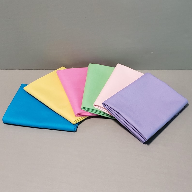 May include: Six fabric swatches in different pastel colors: light blue, yellow, pink, green, light pink, and lavender.