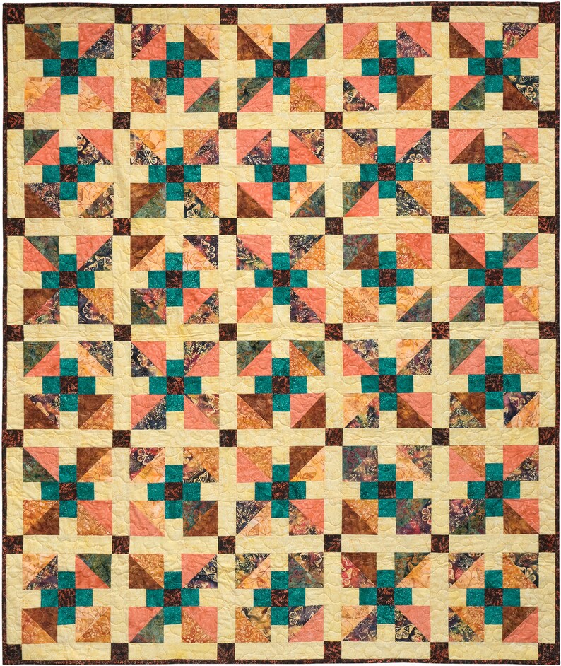 May include: A quilt with a repeating pattern of teal, brown, and pink squares. The squares are arranged in a grid pattern, and each square is made up of smaller triangles.