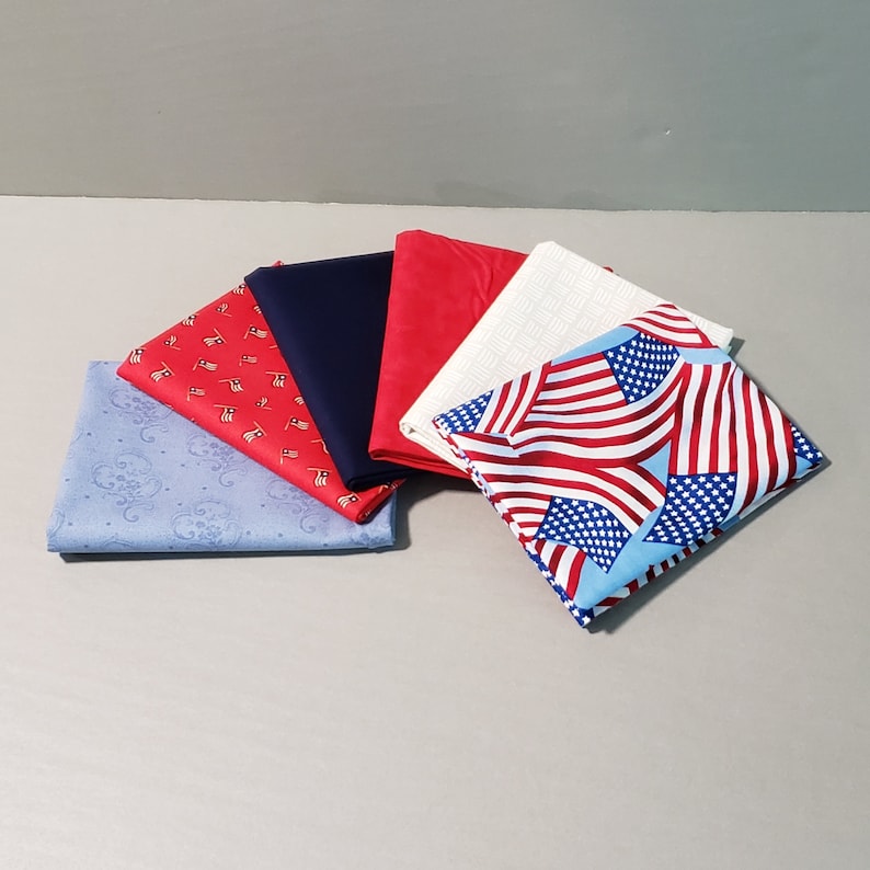 May include: Five fabric swatches in various patterns and colors. The swatches include a blue and white patterned fabric, a red and white patterned fabric, a solid blue fabric, a solid red fabric, and a white fabric with a subtle pattern.
