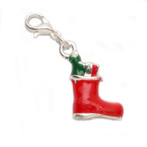 May include: Silver charm in the shape of a red Christmas stocking with a green top and a silver clasp.