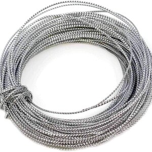May include: A coil of silver metallic cord, tightly wound and knotted at one end. The cord has a textured, braided appearance, reflecting light. Ideal for crafting, jewelry making, or decorative purposes.