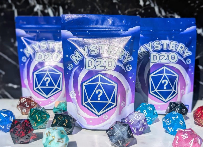May include: Three blue pouches with the text "MYSTERY D20" and a question mark inside a geometric shape. Assorted colorful D20 dice are scattered in front. The pouches have a starry sky design.