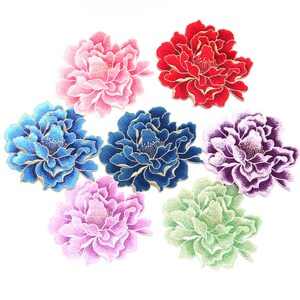 May include: Embroidered flower patches in various colors, including pink, red, blue, purple, and green. Each patch features detailed stitching and a peony flower design. These decorative patches can be used for clothing or craft projects.