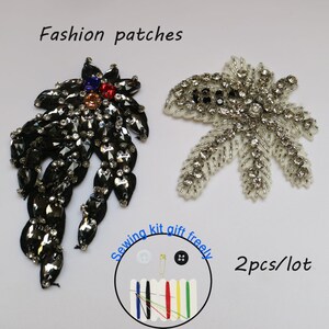 May include: Two black and white beaded flower patches with rhinestones. The patches are 2 inches in diameter. A sewing kit is included with the patches.