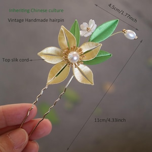 May include: A gold hairpin with a yellow flower and green leaves, decorated with white and pearl beads. The hairpin is 4.5 inches long and 11 inches tall. Inheriting Chinese culture Vintage Handmade hairpin Top slik cord