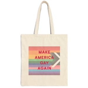 May include: A white canvas tote bag with a rainbow flag design and the text "MAKE AMERICA GAY AGAIN" in red.