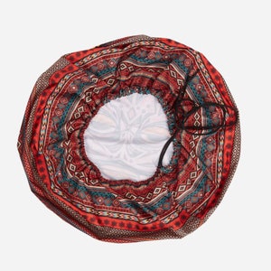 May include: A red, blue, and white patterned satin hair bonnet with a drawstring closure.