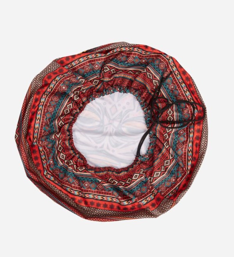 May include: A red, blue, and white patterned satin hair bonnet with a drawstring closure.