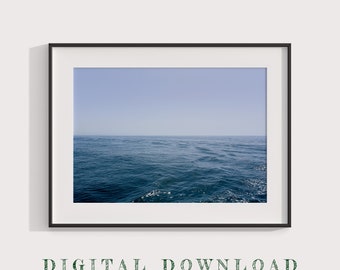 May include: A framed print featuring a seascape with a clear blue sky and deep blue ocean. The water has gentle waves, and the horizon line is visible. The words "DIGITAL DOWNLOAD" are printed at the bottom of the image.