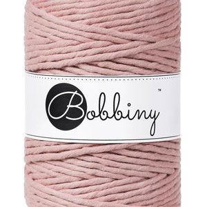 May include: A roll of dusty rose colored cotton rope with a white label that says "Bobbiny&trade;".